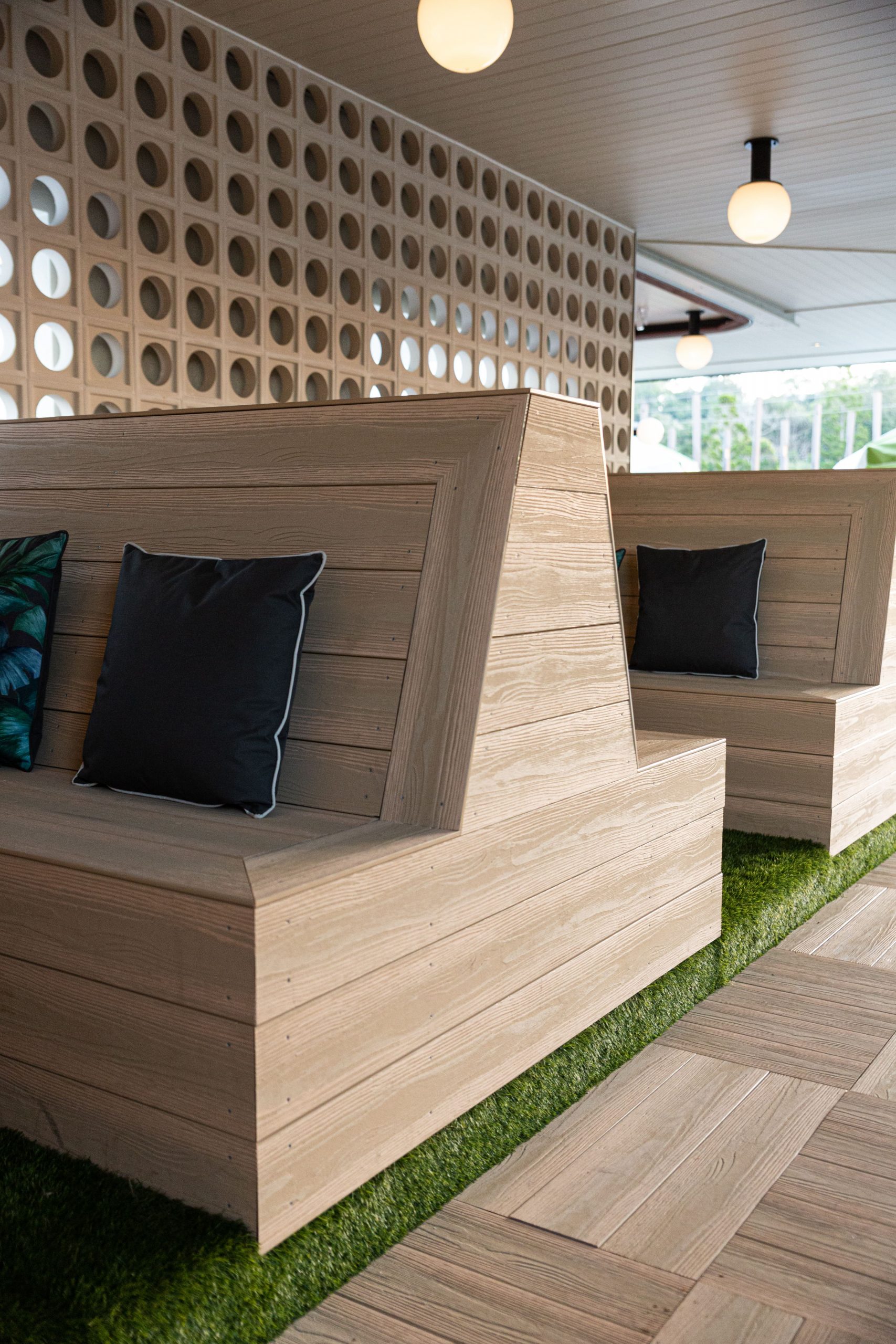 Luxury hotel seating booths made from grey-silver composite decking boards
