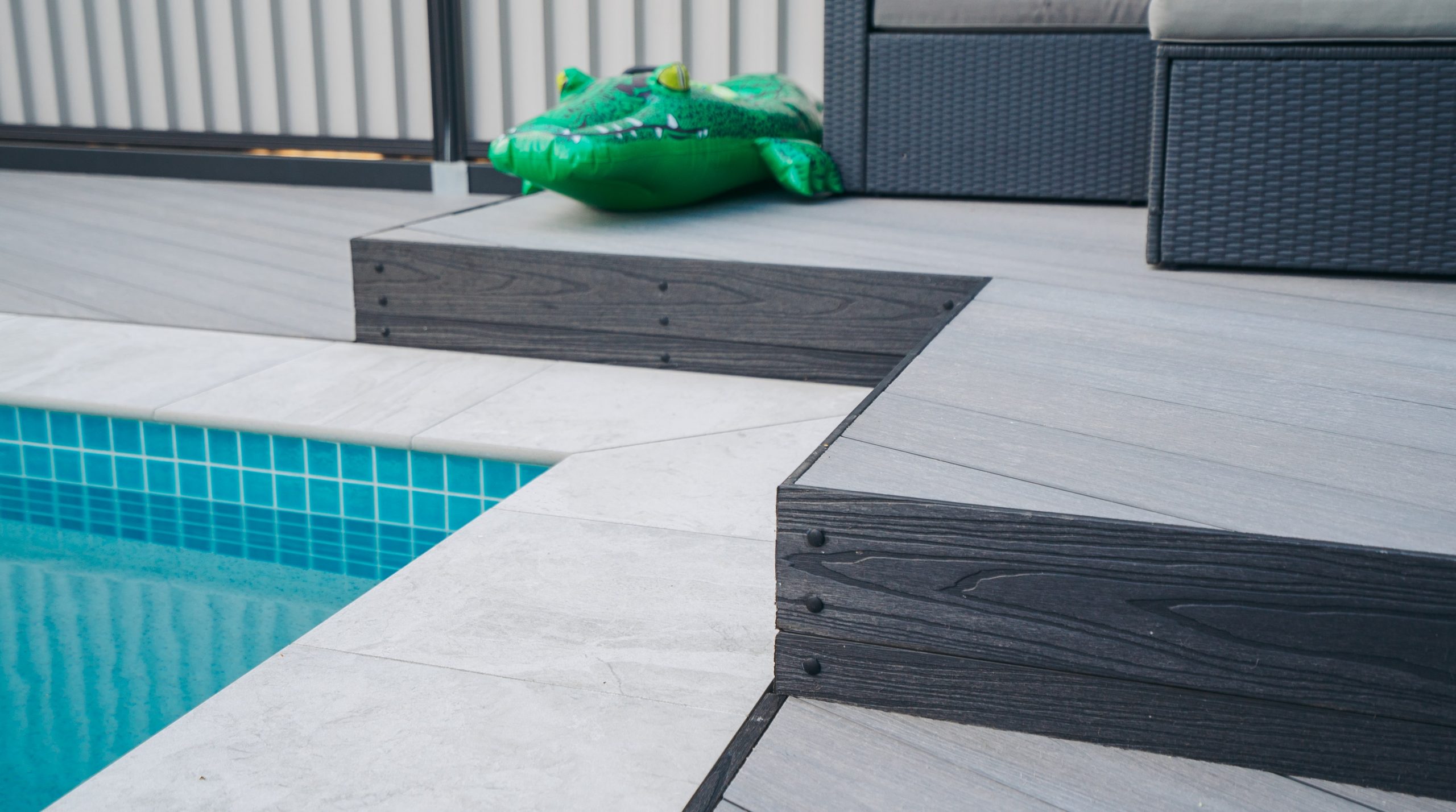 Mountain ash composite decking installed by a pool's edge
