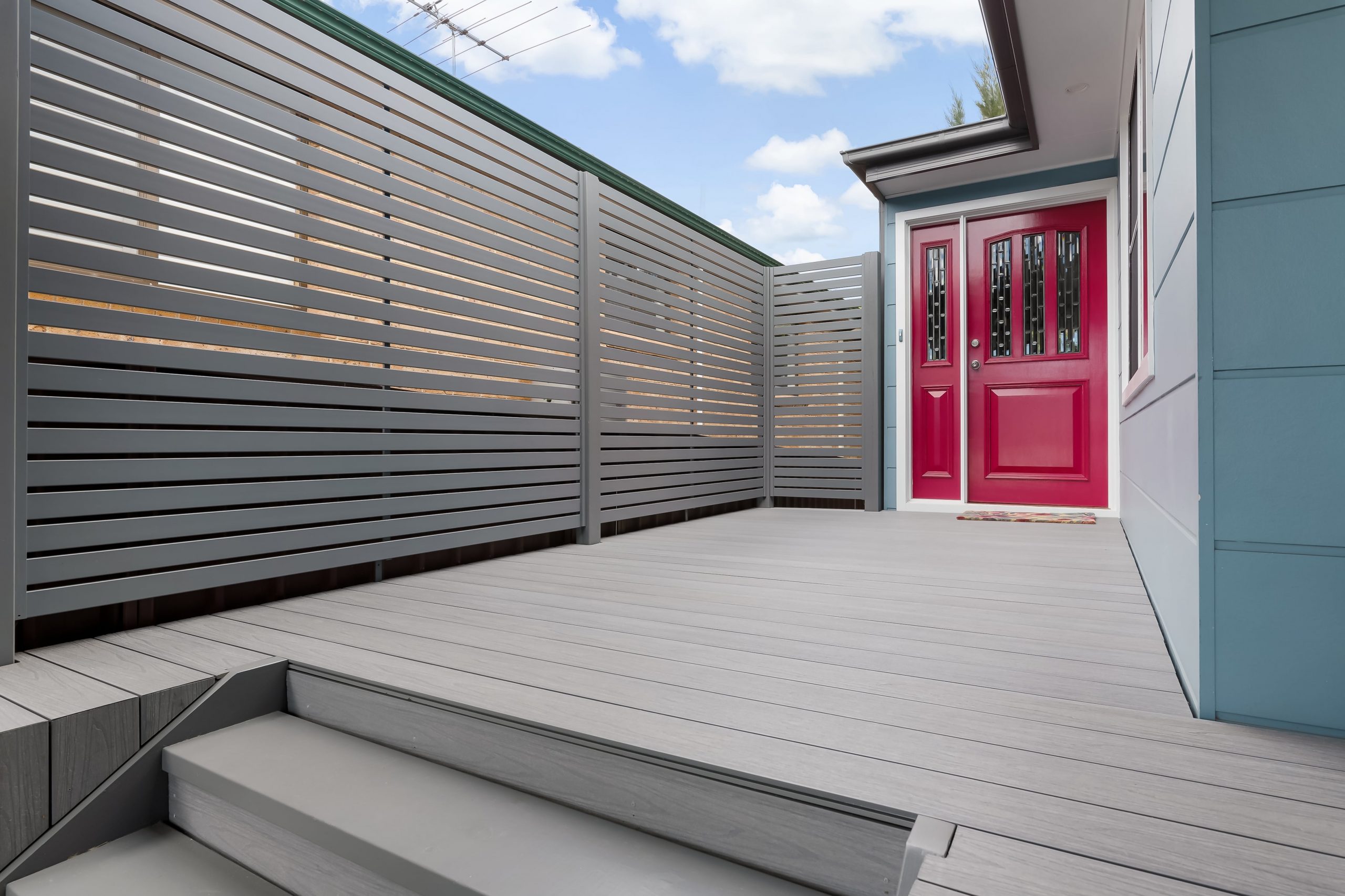 Mountain Ash composite decking boards leading up to a red door