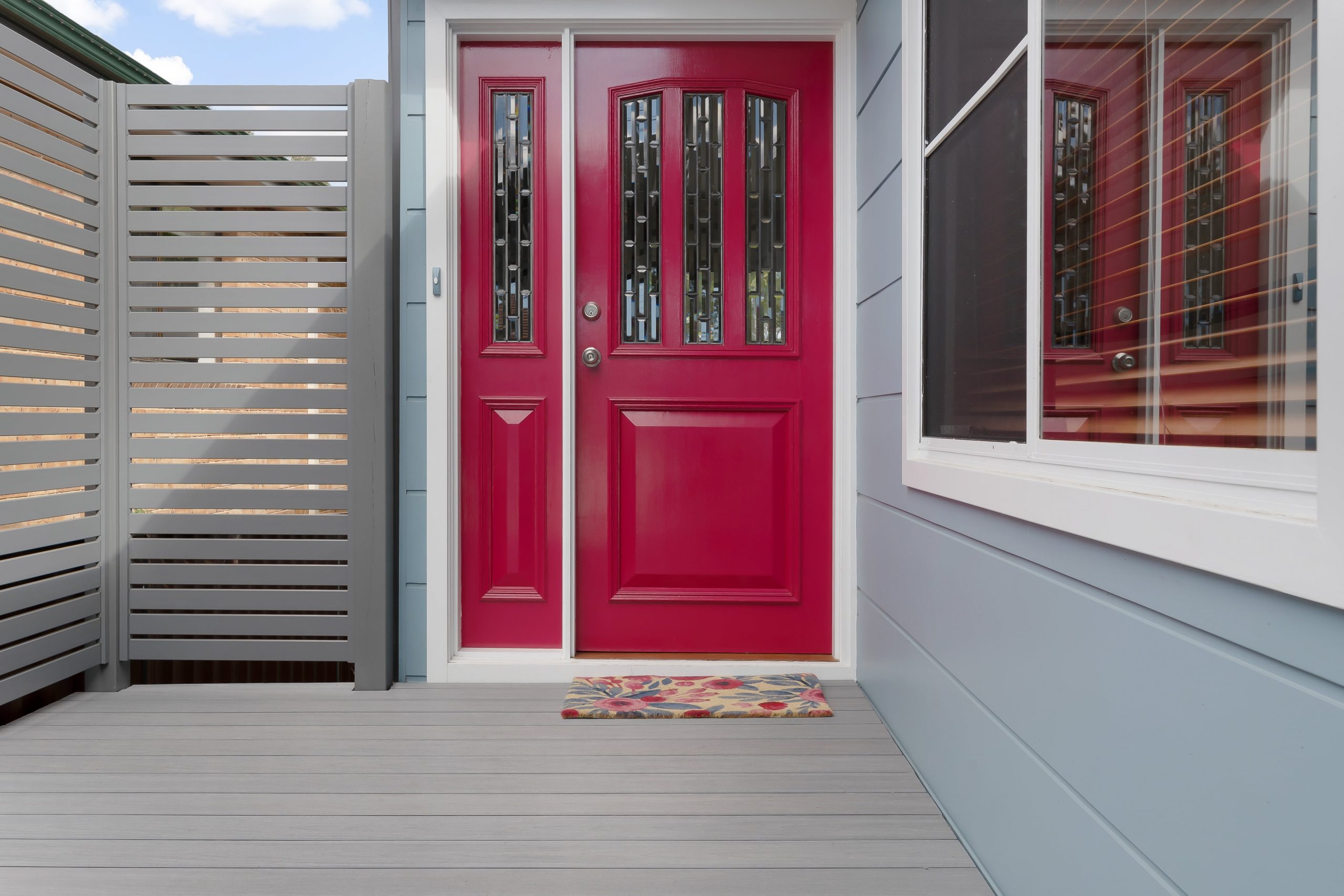 Mountain Ash composite decking boards leading up to a bright red door