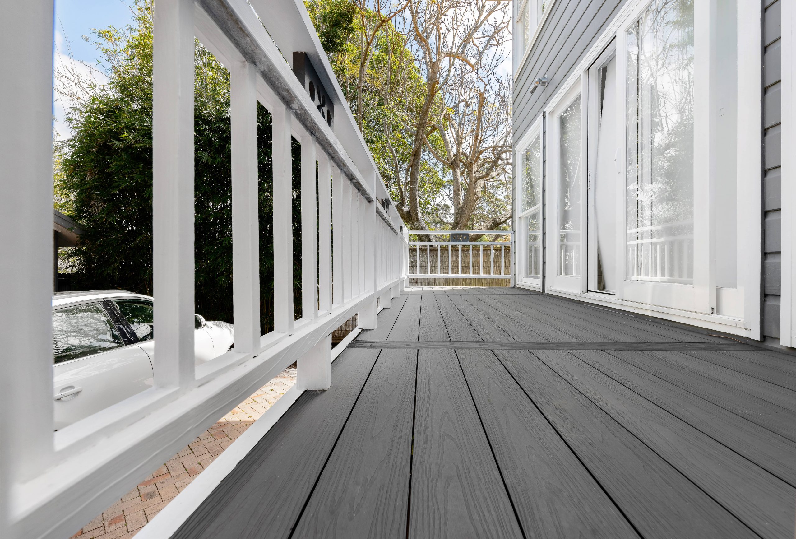 A close up of gray composite decking boards installed on a patio