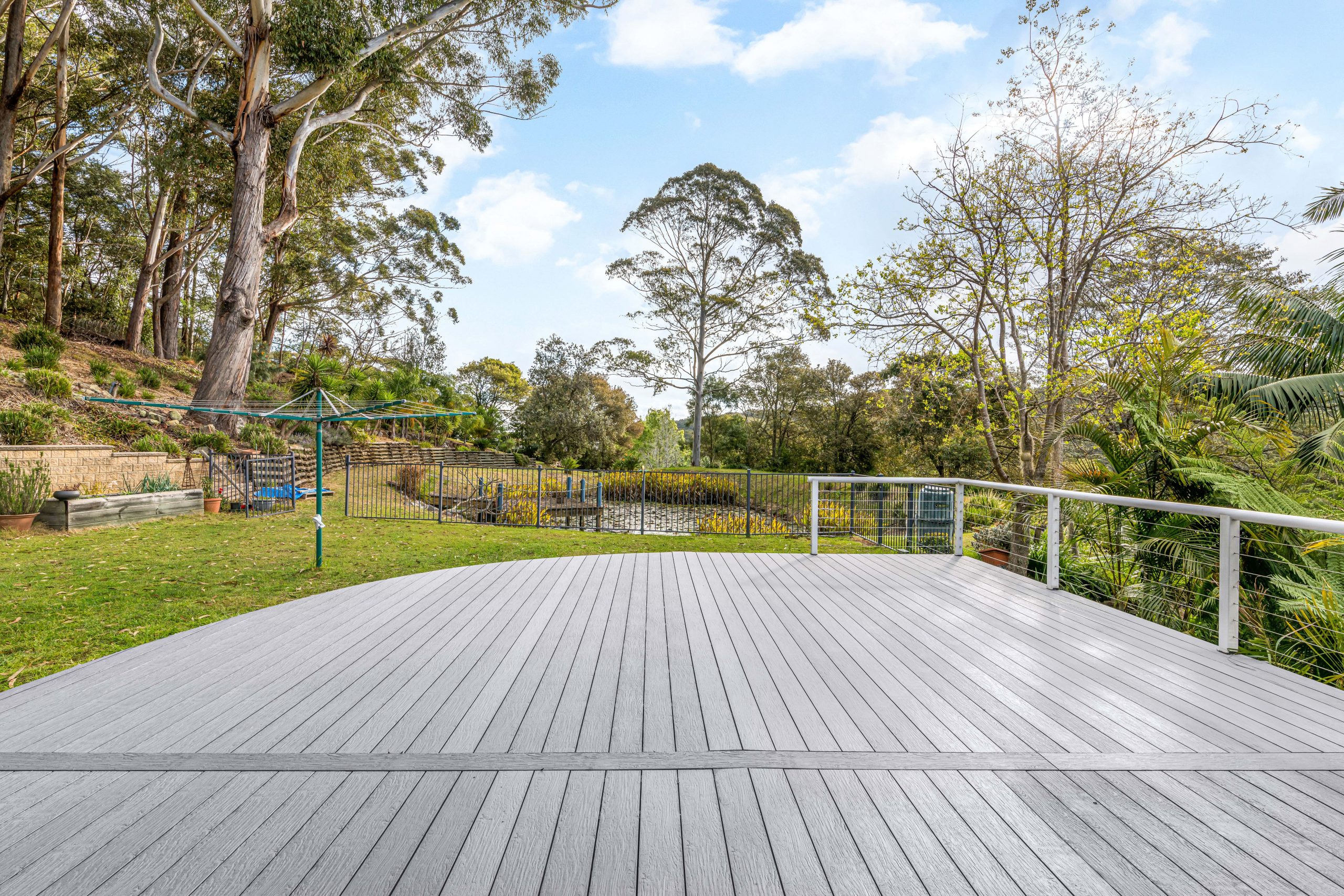 A large composite deck with trees in the distance