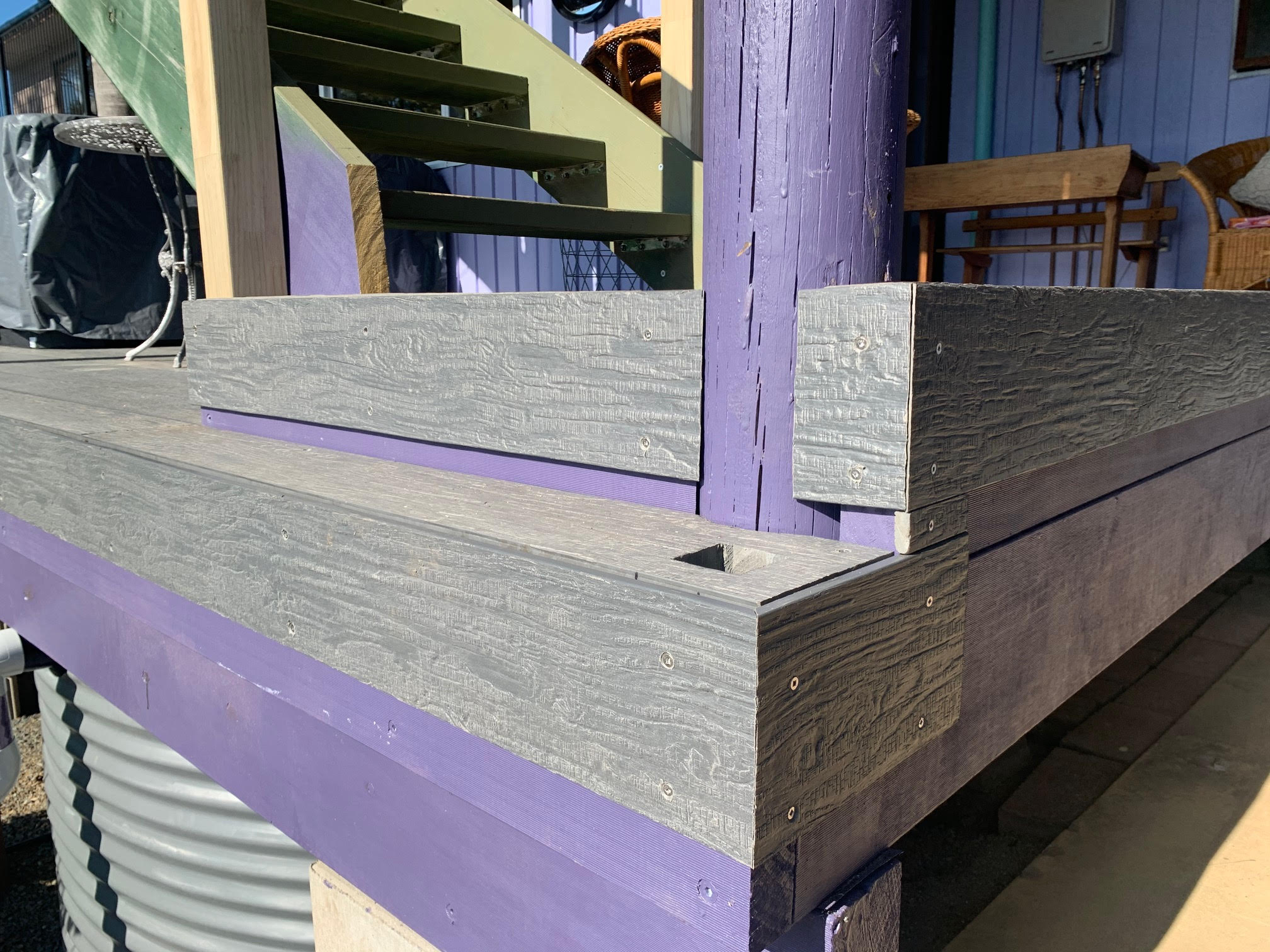 The corners of gray composite decking boards