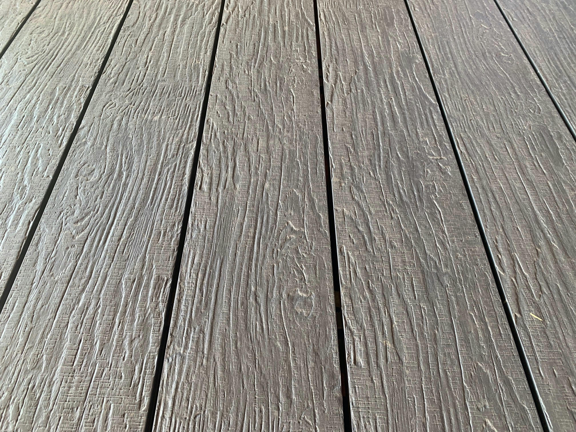 Long grained gray composite decking boards