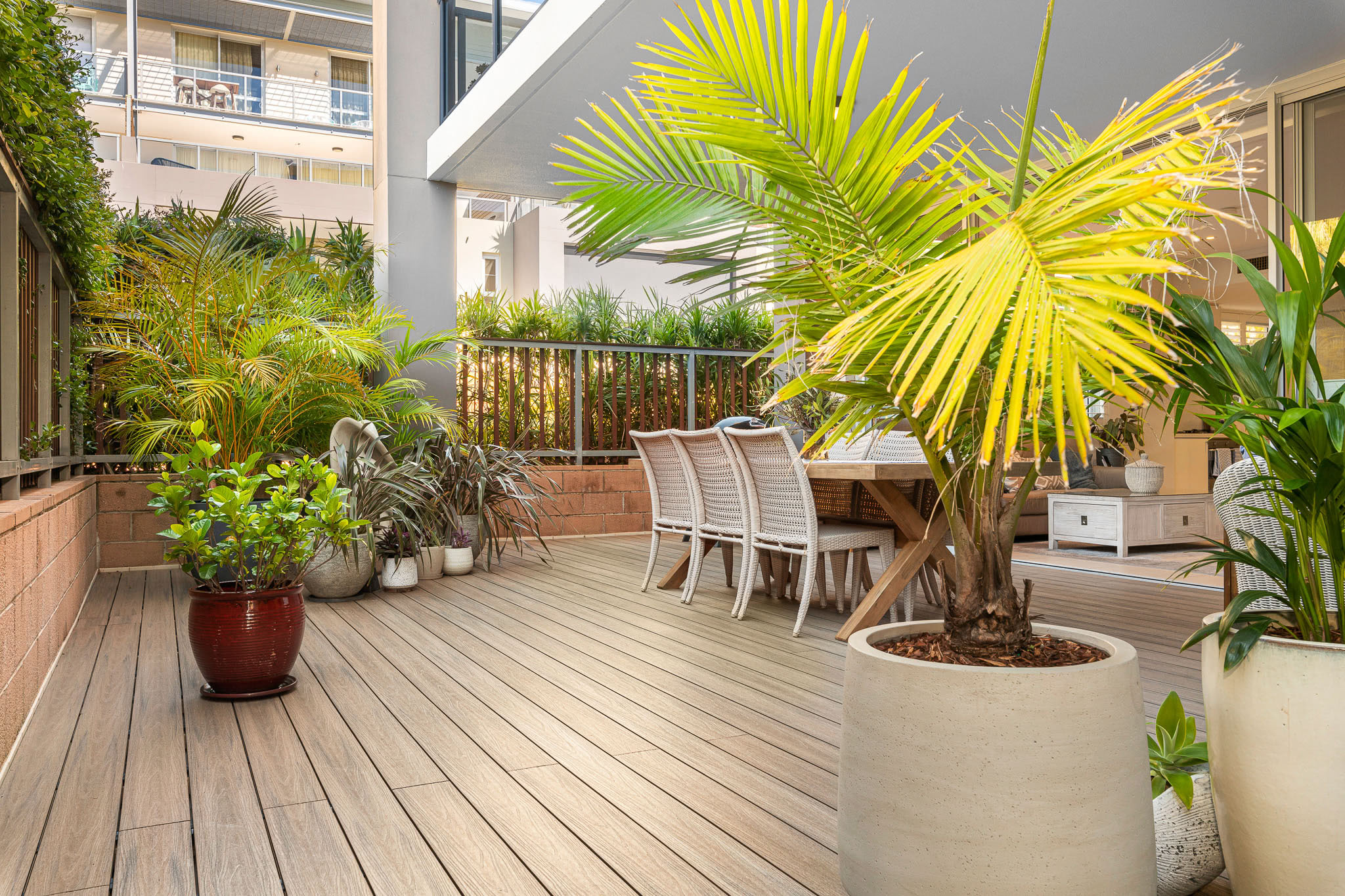 Mountain ash composite decking with large potted plants complimenting the deck's colour