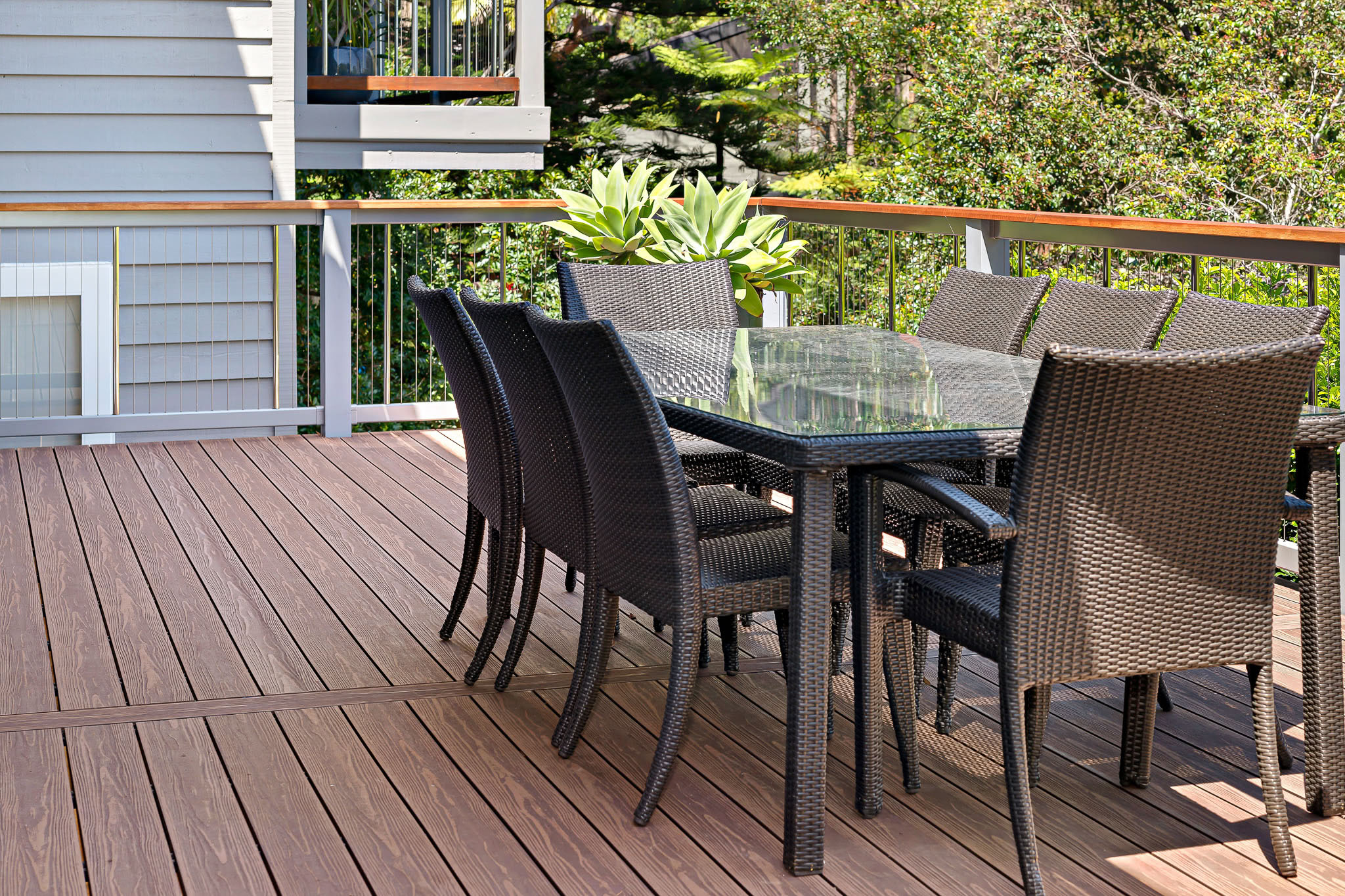 Cane chairs and table accenting an Arabica Composite Deck