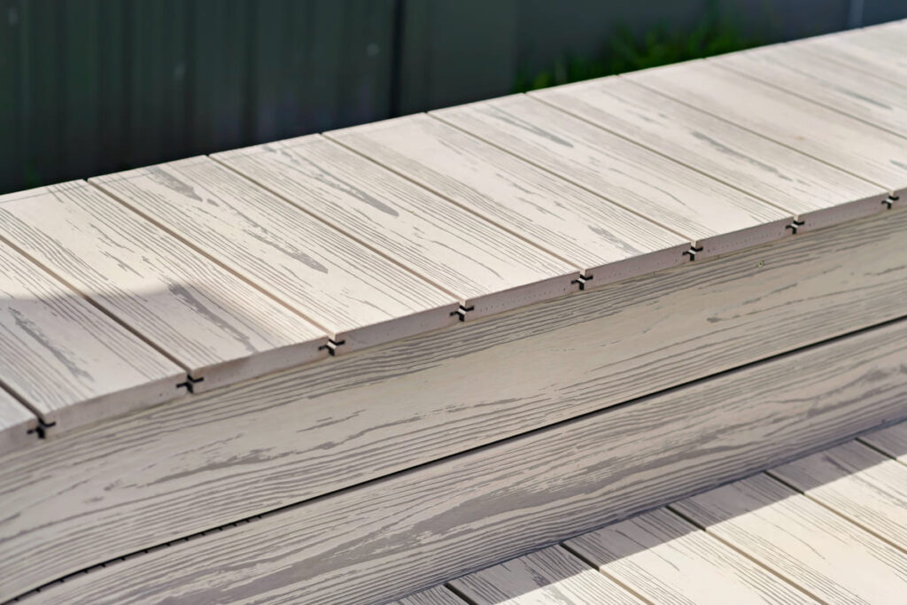 a close up of a grey composite decking bench