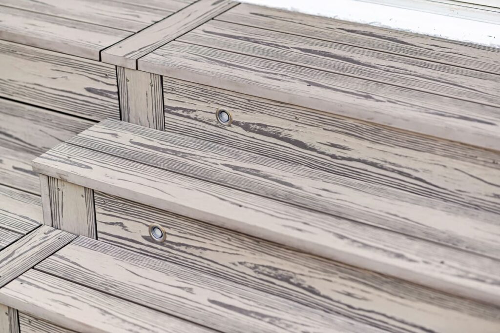 a close up of a grey composite decking stairs