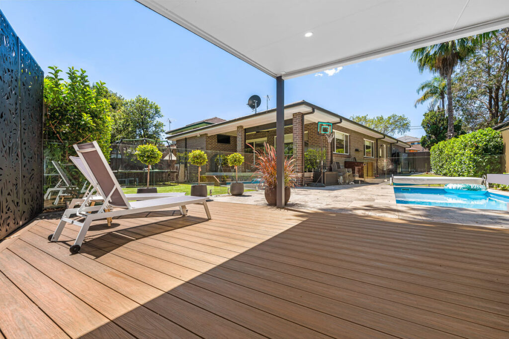 picnic point project img a brown composite decking with a pool and a house