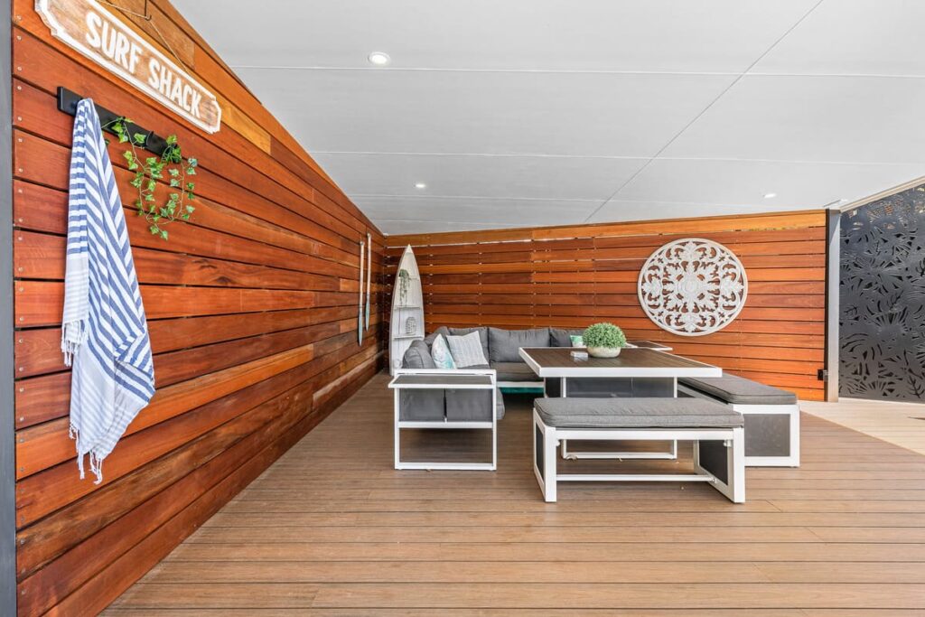 a patio installed with teak composite decking with a table and chairs