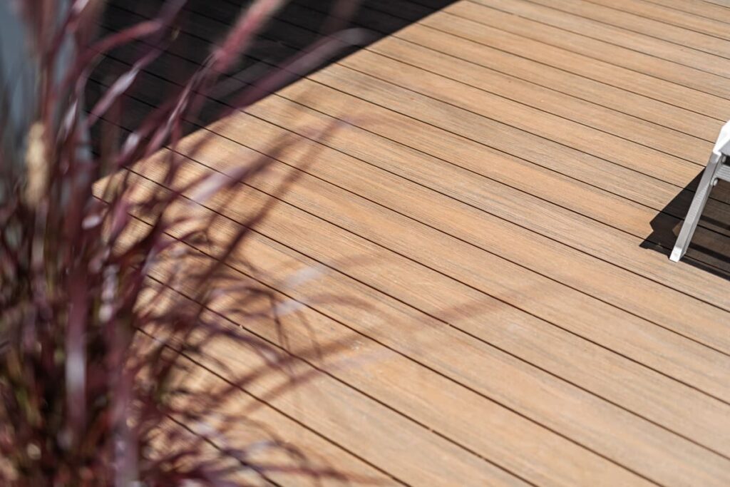 a teak composite decking with purple plant