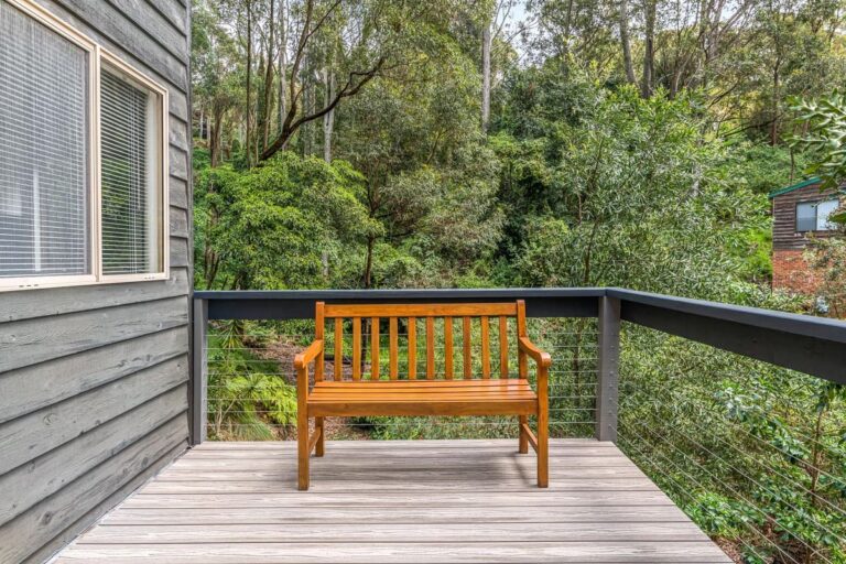 a wooden bench on a grey composite decking