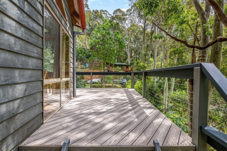 an outdoor with composite decking installed with a view of trees and a car