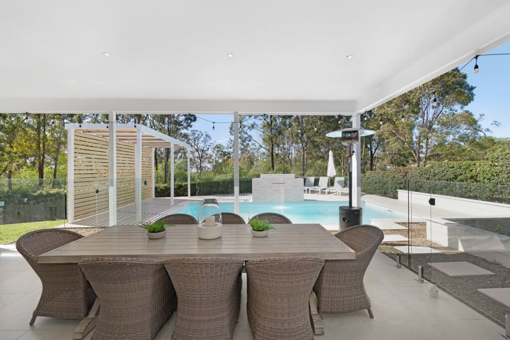 a table and chairs around a pool