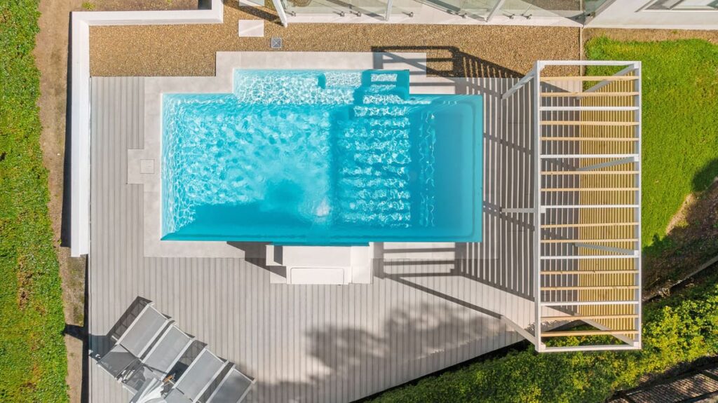 a swimming pool on a beach sand colour composite deck