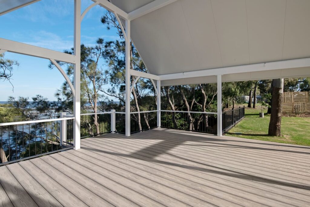 a grey composite deck with a white roof and railings