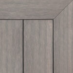 Composite decking board in Fossil finish, soft weathered grey tone with subtle brushed texture and framed corner detail.
