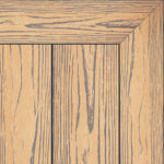 Composite decking board in Pacific Merbau finish, rich reddish-brown timber tone with realistic wood grain texture and framed corner detail.