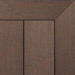 Composite decking board in Pecan finish, warm medium brown tone with subtle wood grain pattern and framed corner detail