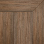 Composite decking board in Teak Wood finish, warm golden-brown tone with fine wood grain texture and framed corner detail.