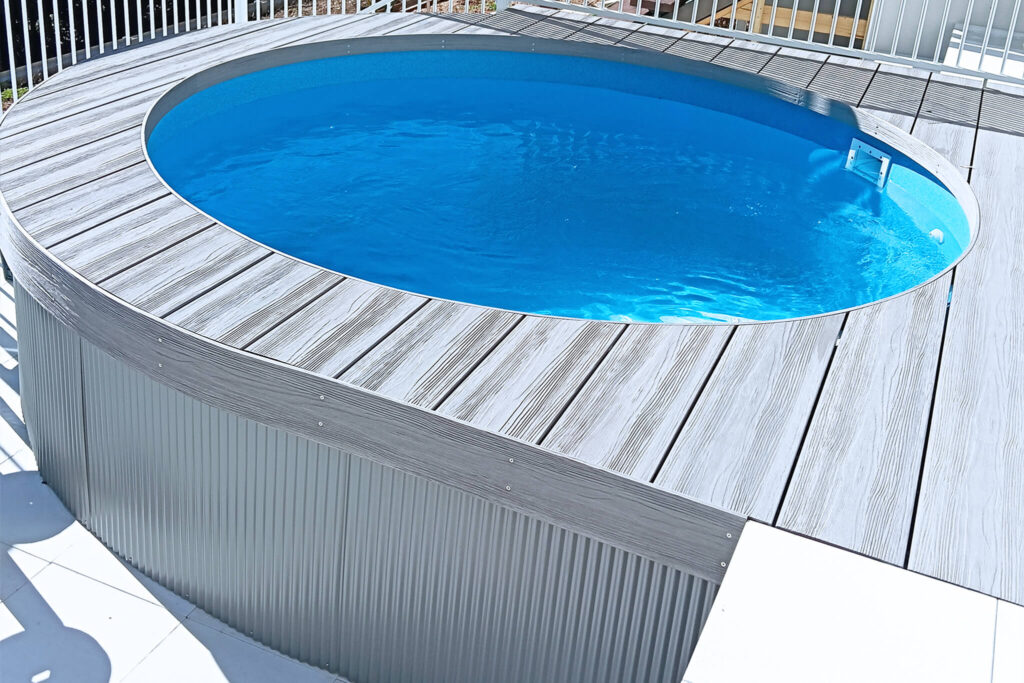 Circular swimming pool with grey-toned composite decking in NextGen Titanium Fossil colour, installed in Buderim QLD