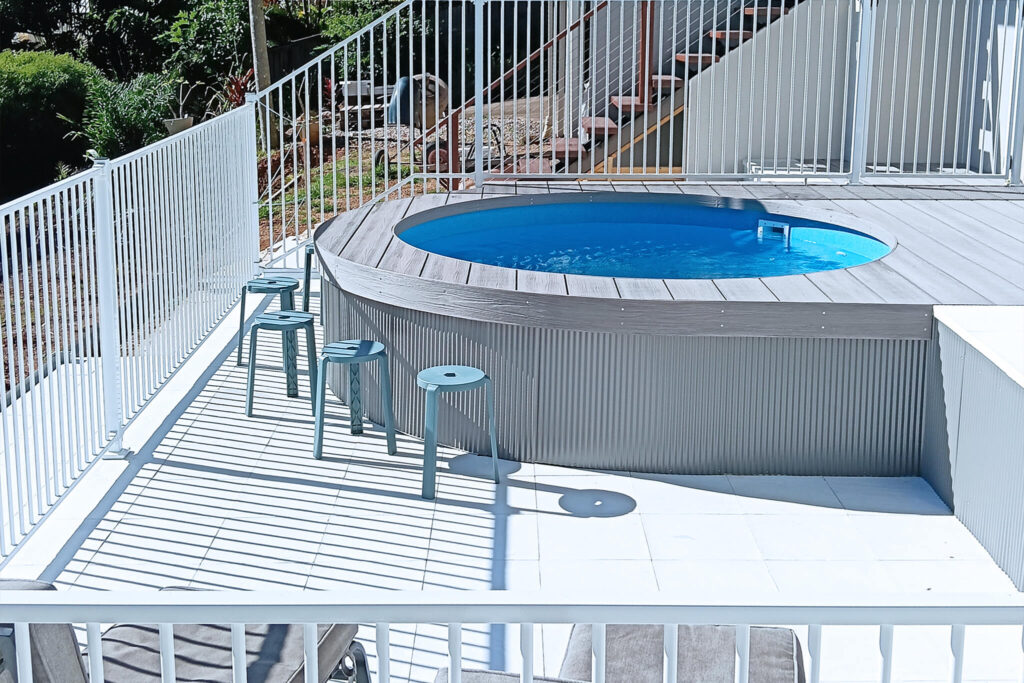 Outdoor pool area in Buderim QLD featuring stools and composite decking in NextGen Titanium Fossil colour