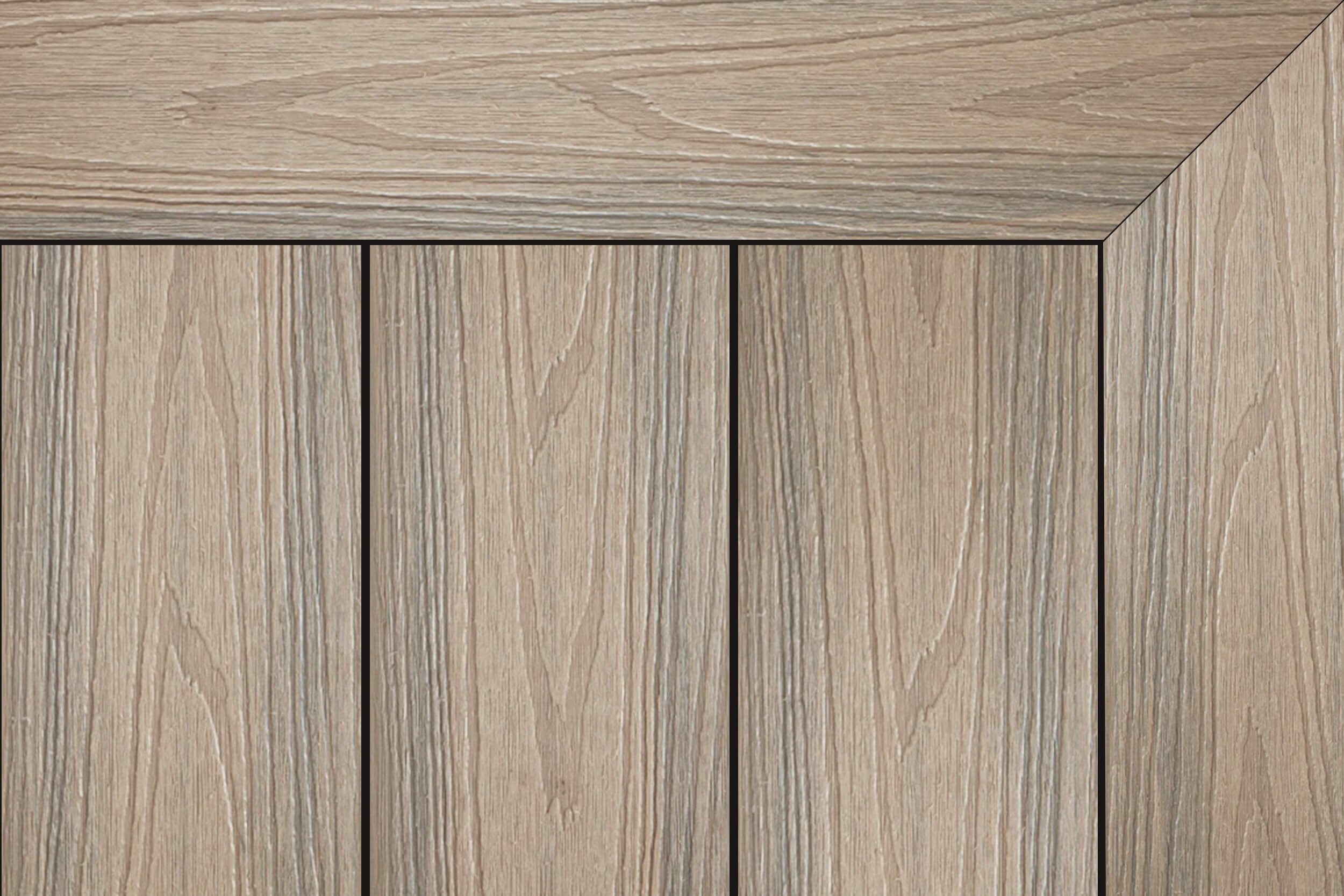 Composite decking in “Antique” colour: warm taupe-brown woodgrain with a mitered picture-frame border and three vertical boards.