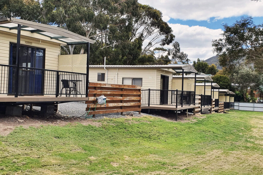 Row of cabins upgraded with composite decking Tasmania at Discovery Parks Hobart caravan park.