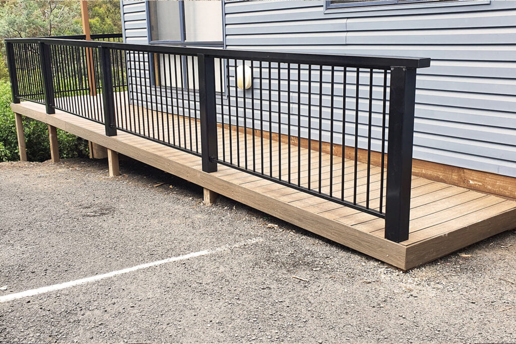 Accessible cabin ramp built with composite decking Tasmania and railing at Discovery Parks Hobart.