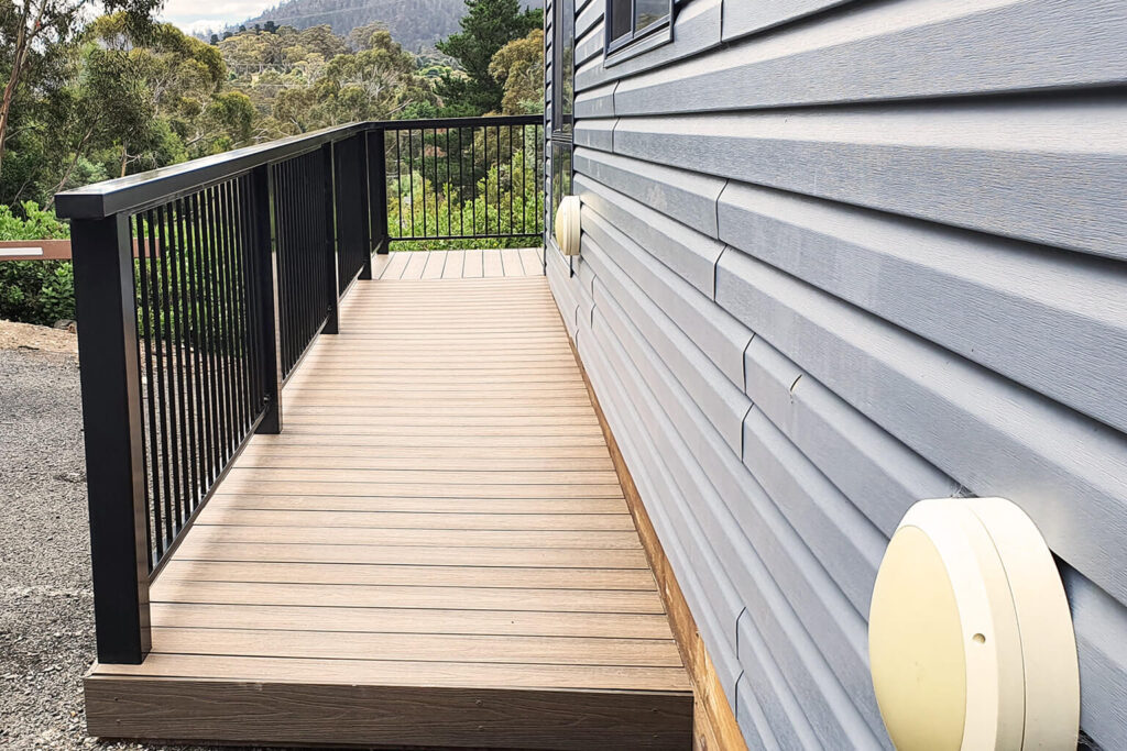 Side view of composite decking Tasmania ramp beside cabin at Discovery Parks Hobart caravan park.