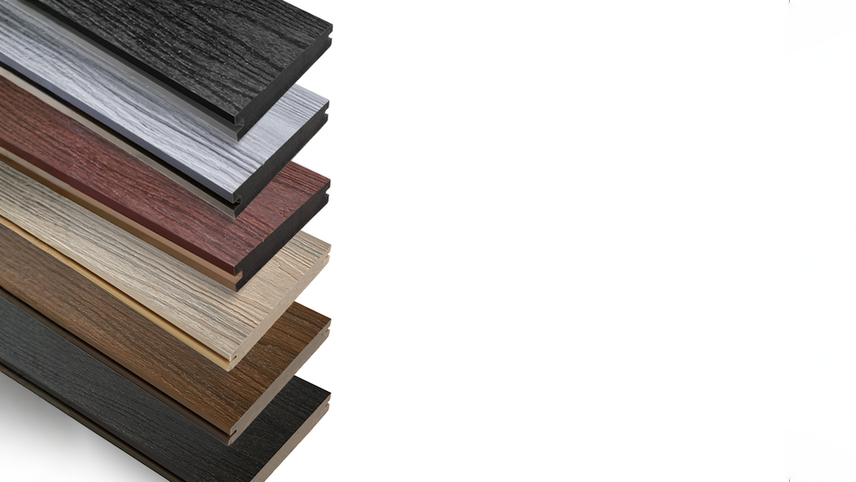 Stacked range of Composite Decking boards in multiple colours and wood grain finishes, showcasing modern profiles and textured surfaces.