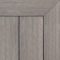 Composite decking board in Fossil finish, soft weathered grey tone with subtle brushed texture and framed corner detail.